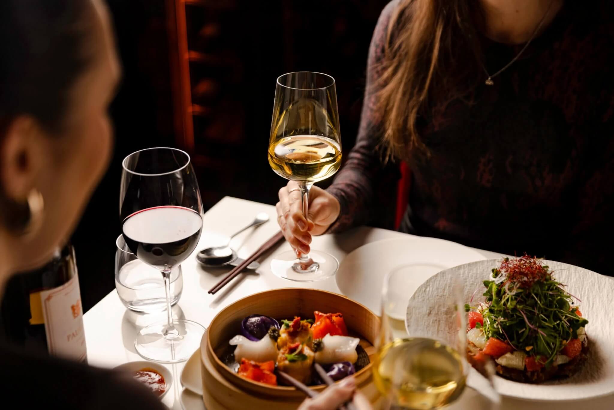 Girl at Table with Wine and Dim Sum